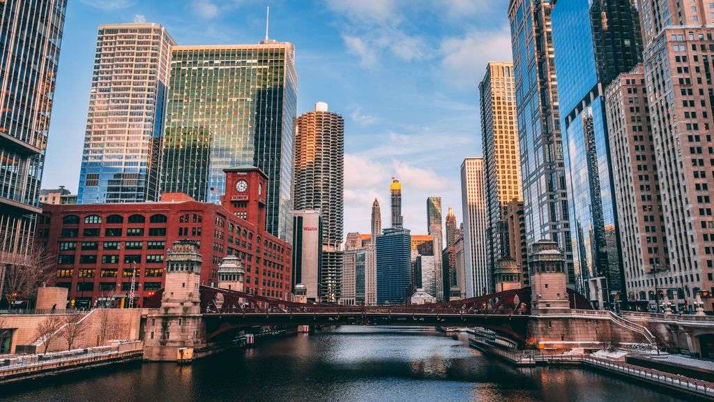 Stunning view of Chicago's skyline reflecting on the river during sunset.