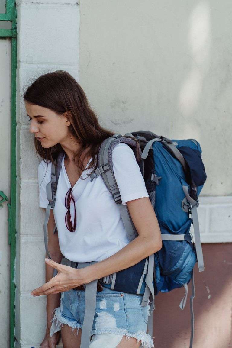 Adventure awaits a young woman traveler with a backpack enjoying the outdoors.
