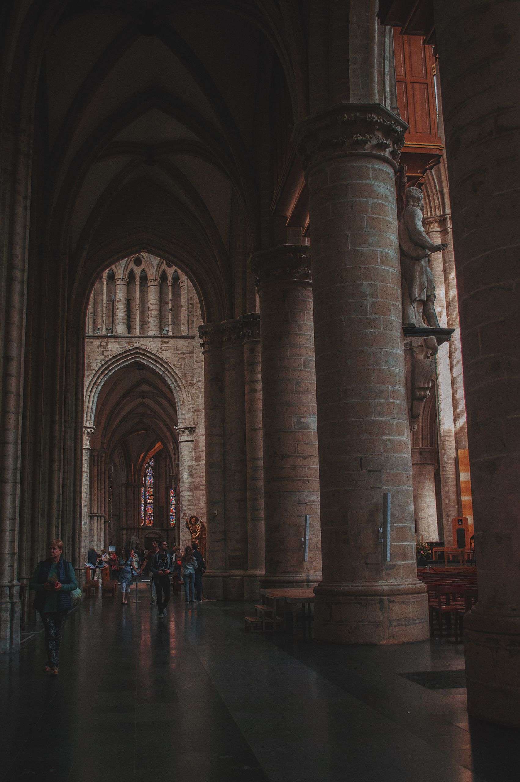 Explore the stunning architecture of a gothic cathedral featuring towering stone columns and dimly lit interiors.